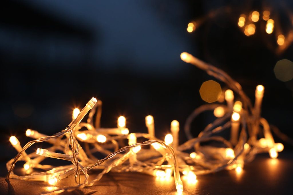 yellow-string-lights-754262 Close-up of warm LED string lights glowing against a dark background.
